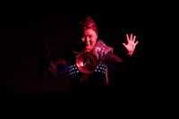 a woman holding a frisbee in the dark