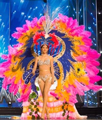 a woman in a colorful costume on stage