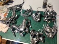 a group of metal masks on a cutting board