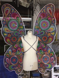 a mannequin with colorful butterfly wings