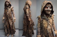a man dressed in a cloak and a hooded cloak